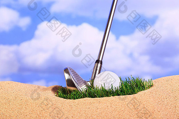 一个球躺在沙坑的草地上的高尔夫概念图。