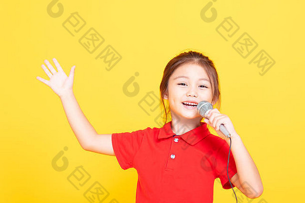 快乐的小女孩在黄色背景上唱歌