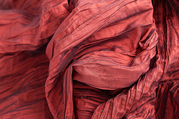 花俏的皱纹红色的织物背景