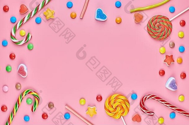 甜蜜的糖果复制空间框架棒棒糖粉红色的背景爱色彩斑斓的甜品童年概念