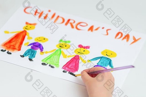 孩子的手在一张白纸上用“儿童节”这个词画出不同颜色的孩子。