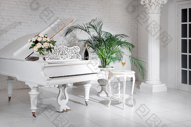 豪华的白色古典内饰，配以葡萄酒、棕榈和鲜花的大钢琴。