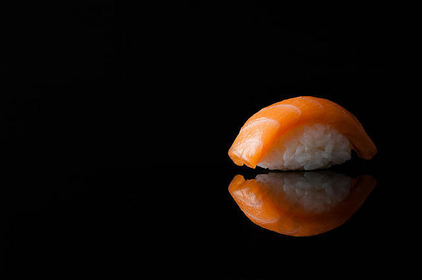 黑色背景上的米饭寿司特写，带反光