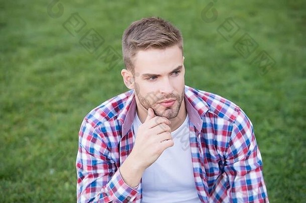不要太年轻而不能开始日常护肤。年轻人坐在绿草上。脸上没有刮胡子的单身汉。护肤化妆品。正确的护肤程序。皮肤美容。<strong>男士护肤品</strong>。