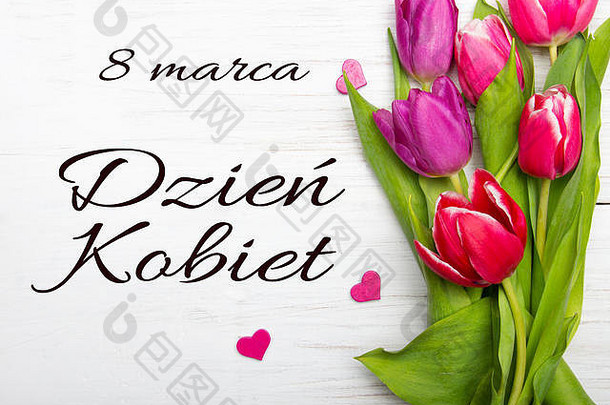 妇女节卡片上印有波兰字DZIEŃKOBIET。白色木质背景上的郁金香花和小心形，空间