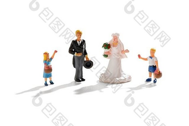 一对微型新婚夫妇，新娘和新郎站在两个年幼的孩子之间，一个花童和一个男孩站在白色背景下的婚礼场景中