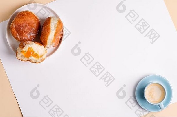 一杯芳香的咖啡和新鲜出炉的美味甜甜圈糖，在浅灰色背景的白色陶瓷盘上上釉，复制空间。顶部