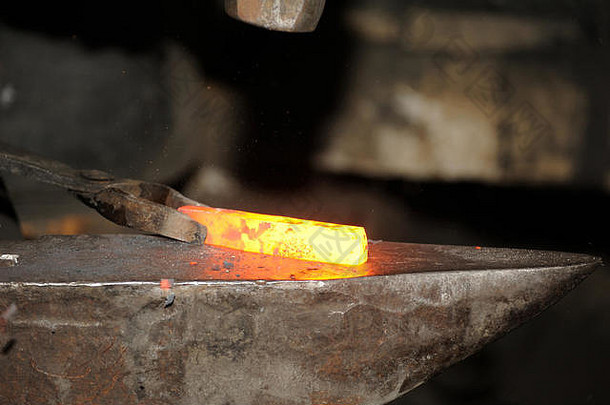 铁匠用锤子在铁砧上锻造金属