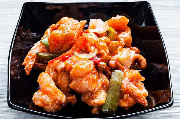 <strong>韩国料理</strong>-黑碗里的腰果炒虾和糖醋汁蔬菜（虾套餐）