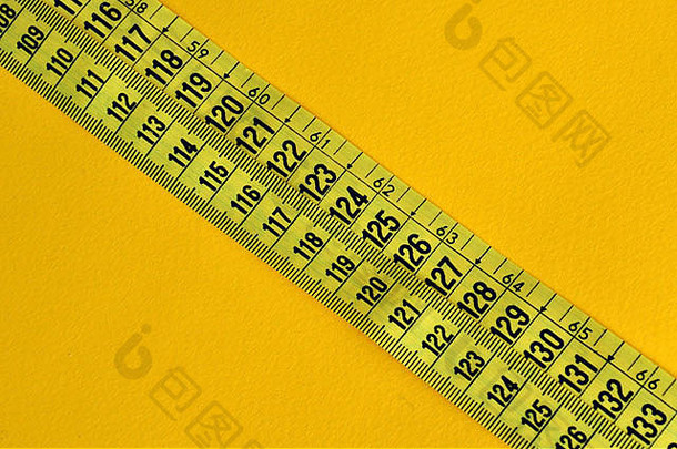 塑料卷尺测量英寸和厘米。摘要数字以黄色为背景。