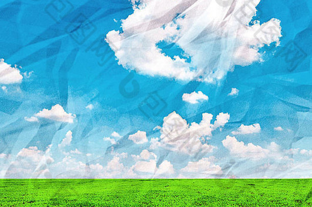 美丽的绿色田野和蓝色的天空在皱巴巴的废纸上