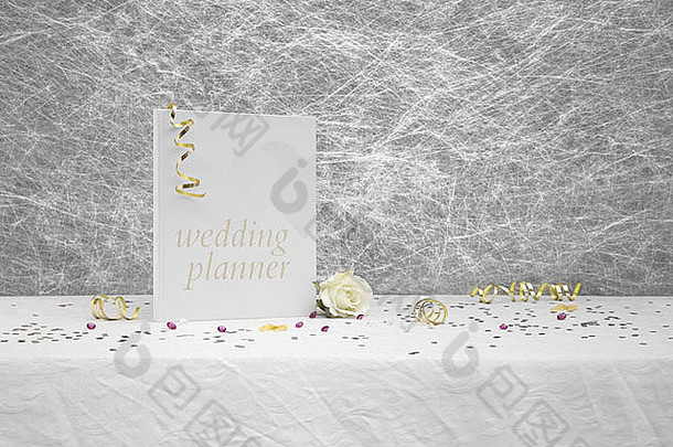 婚礼策划书放在白色桌布上，上面有金色丝带、蝴蝶结、银色心形五彩纸屑和小钻石桌装饰