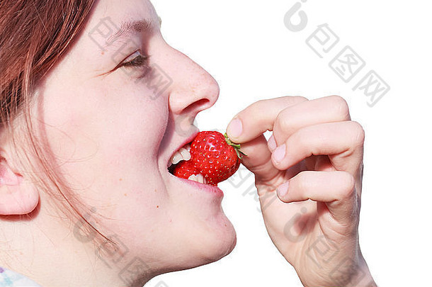 一个年轻貌似自然的女人咬着刚收获的成熟草莓