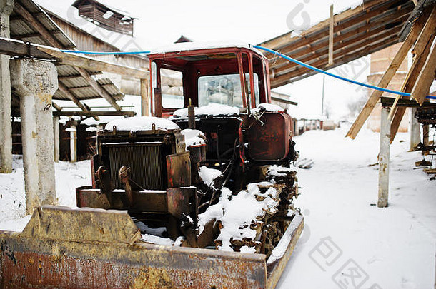 生锈的苏联拖拉机覆盖雪