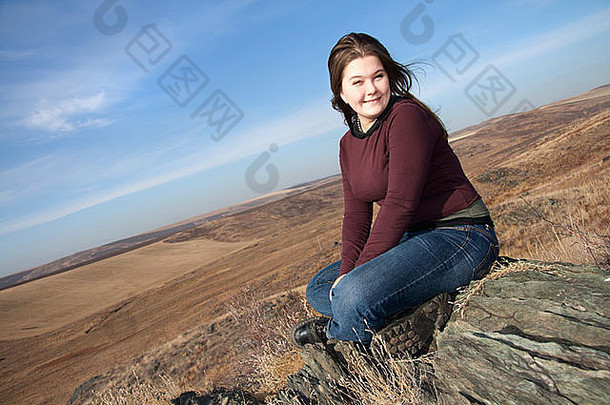 女孩微笑坐在石头秋天