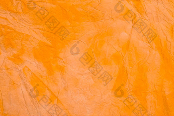 橙色有皱纹的彩色的组织纸背景纹理宏