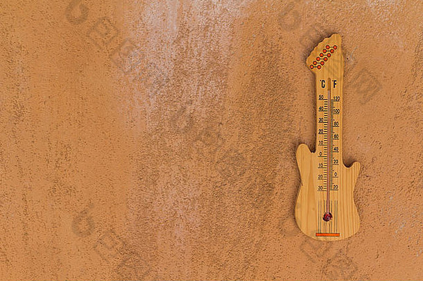 温度计形状的吉他水泥墙背景