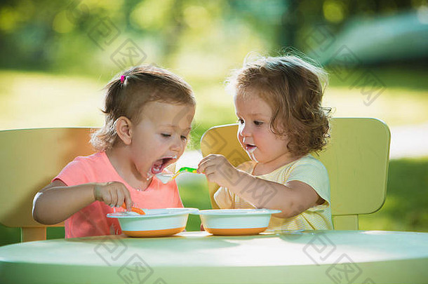 女孩坐着表格吃绿色草坪上