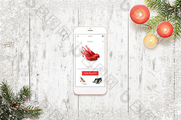 购物聪明的电话圣诞节时间女人鞋子电子商务网络网站应用程序前视图白色木表格