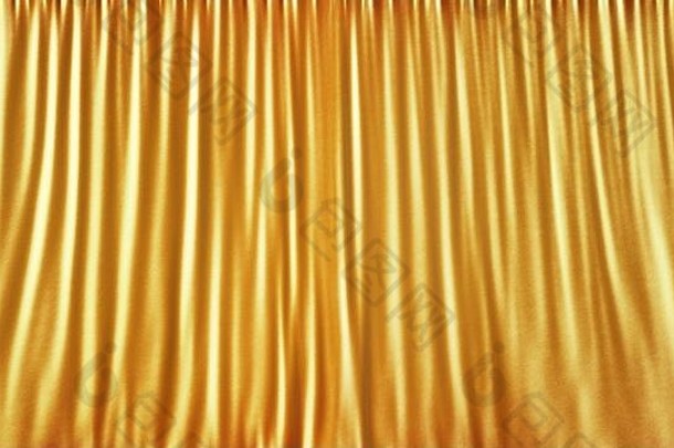 优雅的黄金阶段布窗帘摘要背景黄金缎丝绸背景光黄金织物窗帘呈现
