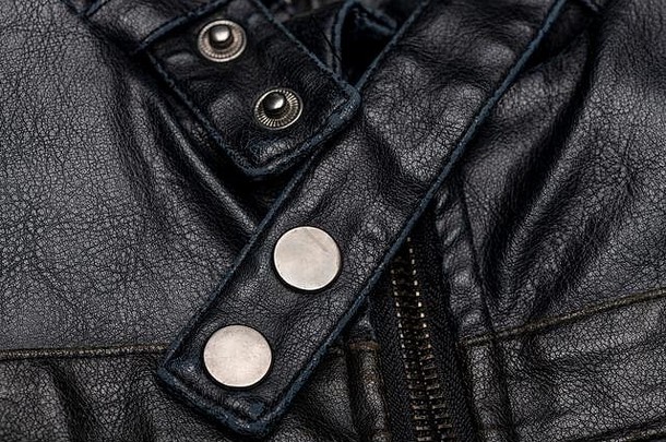 关闭黑色的皮革古董摩托车夹克拉链新闻钉