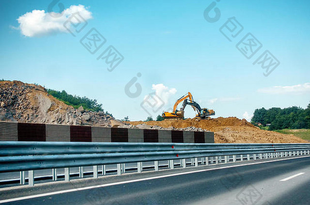 重黄色的黑色的挖掘机建设网站移动土壤岩石高速公路路建设繁荣交叉