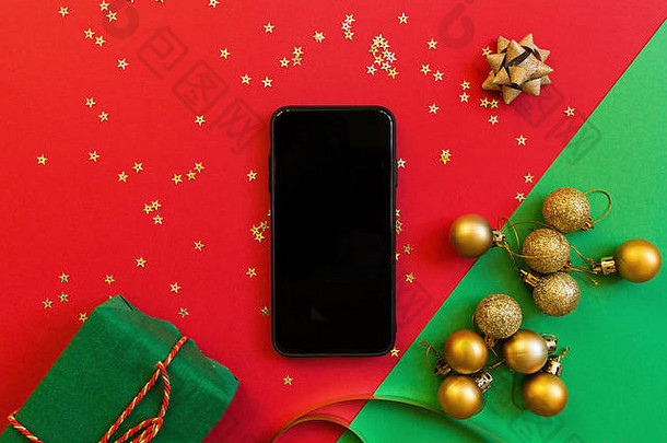 圣诞节作文绿色礼物盒子移动电话红色的绿色背景金五彩纸屑一年概念问候卡圣诞节