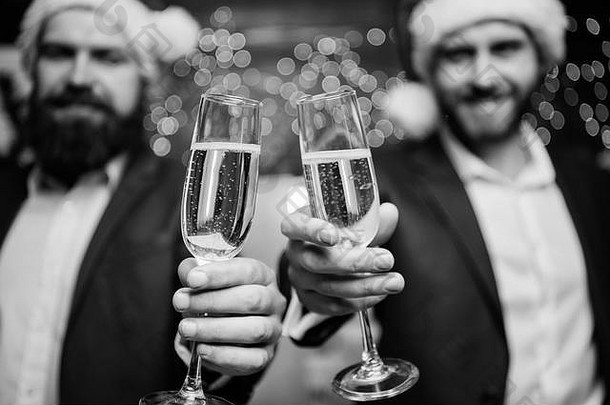 业务人喝香槟聚会，派对的同事们庆祝一年但正式的西装圣诞老人帽子持有香槟眼镜干杯概念一年企业聚会，派对聚会，派对香槟