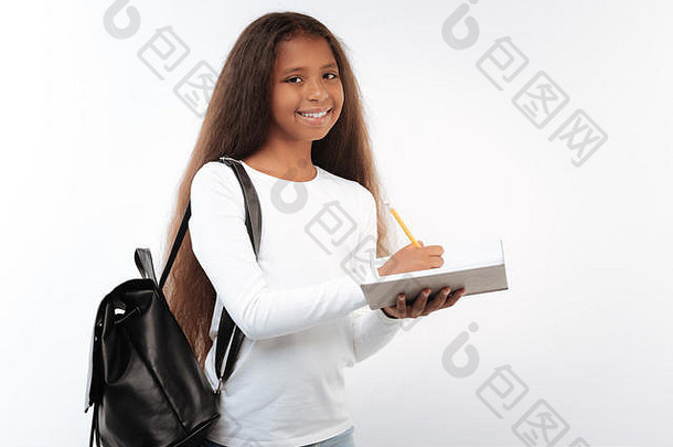 漂亮的女学生摆姿势背包笔记本