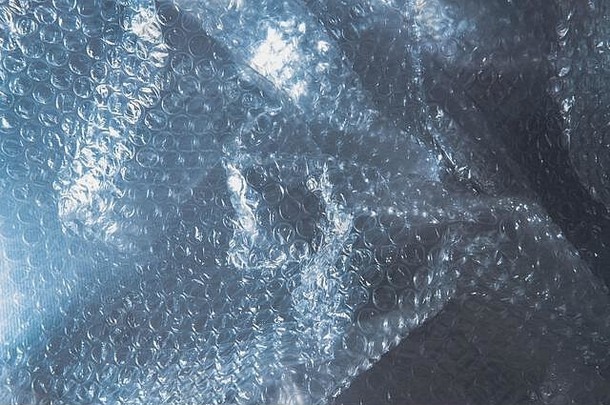 塑料泡沫包装纹理背景蓝色的泡沫包拍摄低关键