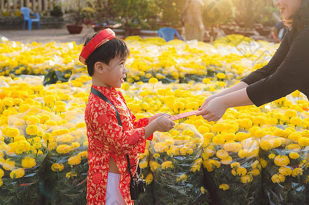 肖像亚洲男孩传统的节日服装可爱的越南男孩戴曼菊衣服微笑泰特假期月球一年越南