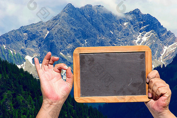 人类手显示标志持有板岩黑板上空白广告空间空气背景山