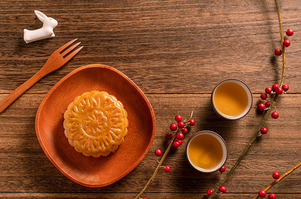 有创意的月亮蛋糕月饼表格设计中国人传统的糕点茶杯木背景中秋节日概念前视图平