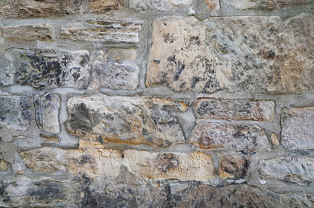 饱经风霜的自然石头墙砌筑背景纹理