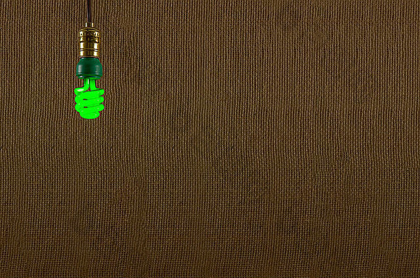 单挂绿色断续器紧凑的荧光灯前面变形粗麻布背景