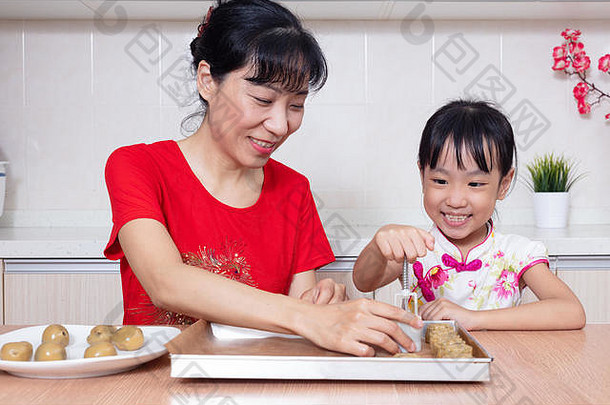 亚洲中国人妈妈。女儿使月亮蛋糕厨房首页