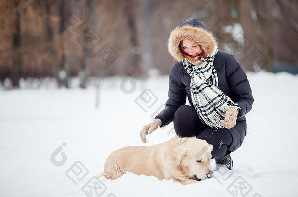 图片女人蹲拉布拉多冬天公园
