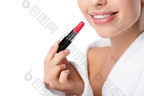 部分视图微笑女人浴袍持有红色的口红孤立的白色