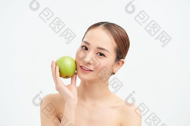 漂亮的健康的年轻的女人微笑持有绿色苹果