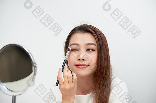 关闭美丽的脸亚洲年轻的女人化妆亚洲女人应用眼影眉刷美丽的女孩