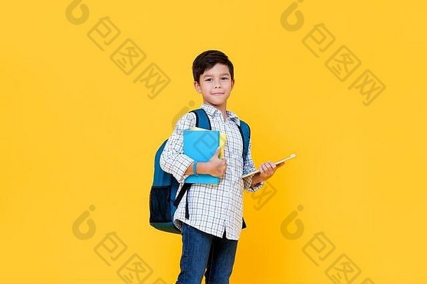英俊的岁的男孩背包持有书平板电脑电脑黄色的背景教育概念