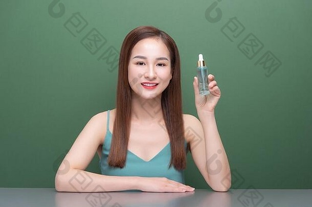 肖像年轻的美丽的亚洲女人皮肤护理血清产品白色背景