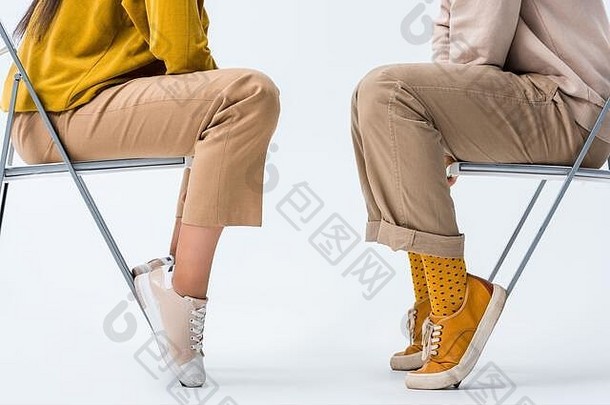 裁剪视图男人。女人坐着椅子白色