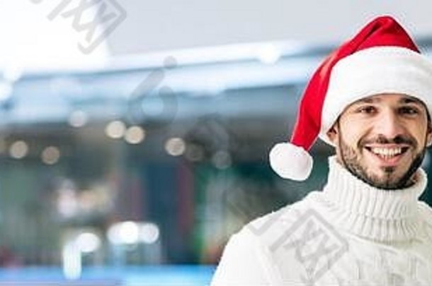 全景拍摄英俊的快乐的男人。毛衣圣诞老人他滑冰溜冰场