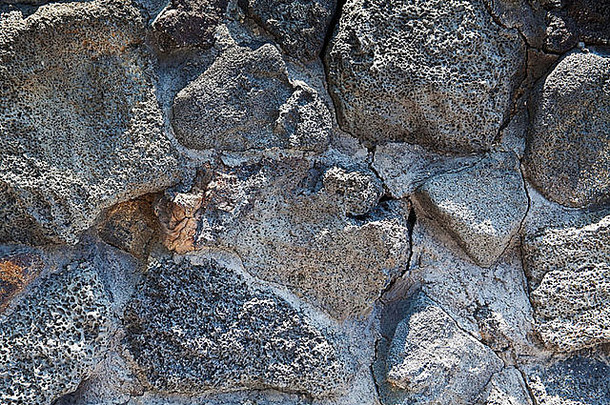 夏威夷黑色的熔岩岩石墙背景