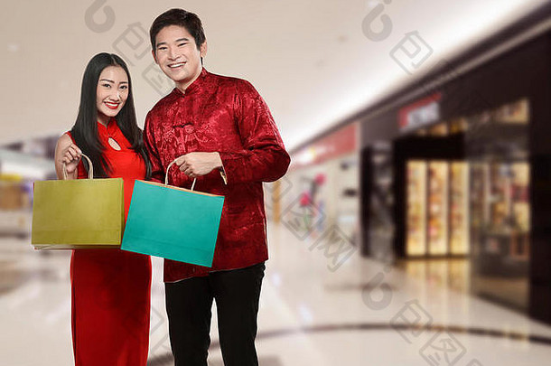 亚洲夫妇持有购物袋