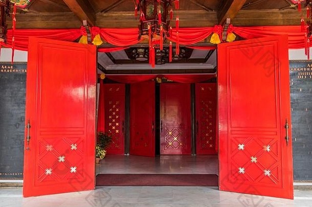 中国农历新年庆祝活动之前更换灯笼内保持寺庙入口红色的门色彩斑斓的中国人艺术(泥马来西亚