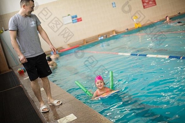 漂亮的女孩学习游泳池游泳教练教练