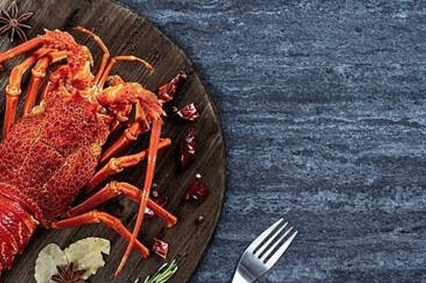 煮熟的煮熟的龙虾美味的晚餐海鲜餐集刀叉黑色的石头板岩背景餐厅菜单设计前视图奥弗赫