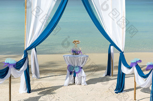 美丽的热带海滩装饰婚礼绿廊蓝色的白色材料准备仪式中心可见表格champagn